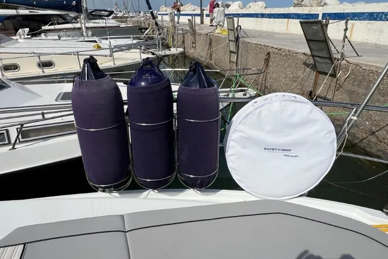  Yacht Photos Pics 2025 Jeanneau Merry Fisher 1095 with fenders and safety ring at dockside.