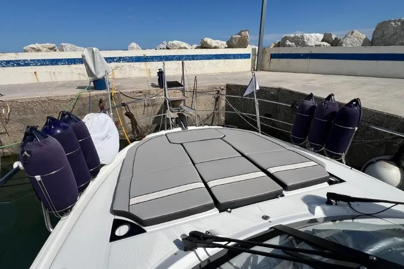  Yacht Photos Pics 2025 Jeanneau Merry Fisher 1095 docked, featuring cushioned deck and protective fenders.