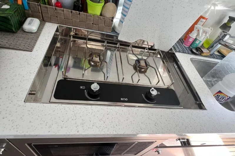  Yacht Photos Pics Modern kitchen stove on Jeanneau Merry Fisher 1095, 2025 model, with sleek countertop design.