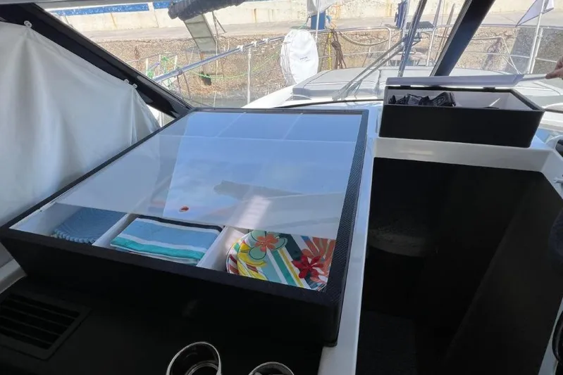  Yacht Photos Pics Interior view of 2025 Jeanneau Merry Fisher 1095 with organized storage compartments.