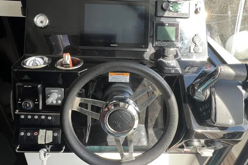  Yacht Photos Pics Helm of 2025 Jeanneau Merry Fisher 1095 with modern navigation controls and steering wheel.
