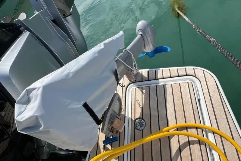  Yacht Photos Pics 2025 Jeanneau Merry Fisher 1095 boat deck with motor and covered equipment.