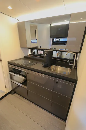 Sapore Di Mare Yacht Photos Pics Modern kitchen interior of 2022 Azimut 47 VERVE yacht with sleek cabinetry and appliances.
