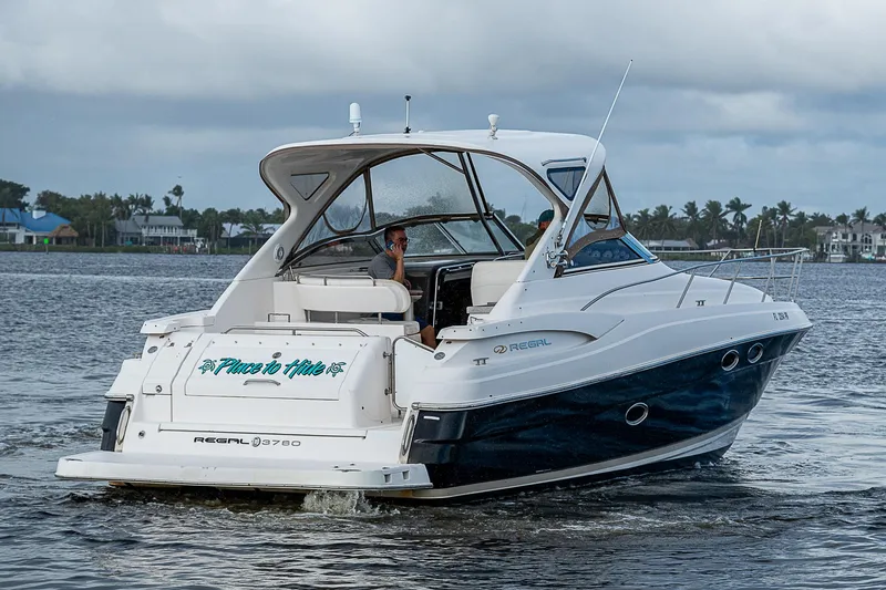  Yacht Photos Pics 2008 Regal Commodore 3760 IB cruising on a calm lake.
