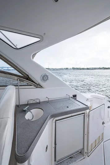  Yacht Photos Pics 2008 Regal Commodore 3760 IB yacht interior with kitchenette, overlooking serene water view.