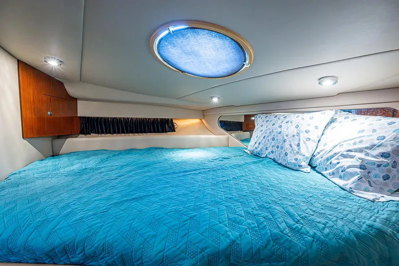  Yacht Photos Pics Cozy cabin interior of 2008 Regal Commodore 3760 IB with blue bedding and ambient lighting.