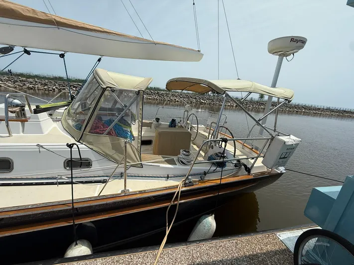 Chapter 9 Yacht Photos Pics Sailboat docked at marina, Tartan 4000 model, 2012, with beige canopy and radar equipment.