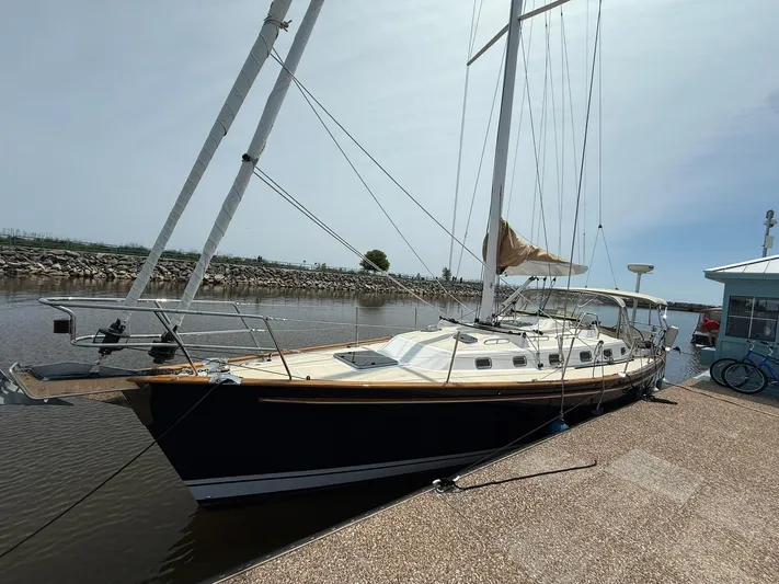 Chapter 9 Yacht Photos Pics Sailboat docked at marina, Tartan 4000 model, 2012, with clear sky background.