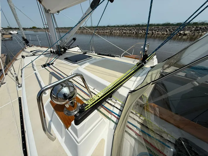Chapter 9 Yacht Photos Pics Sailboat deck of 2012 Tartan 4000, featuring rigging and winch, docked by a calm river.