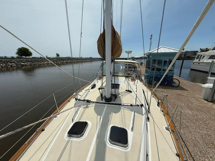 Chapter 9 Yacht Photos Pics Sailboat docked at marina, Tartan 4000 model, 2012, with clear sky and calm water.