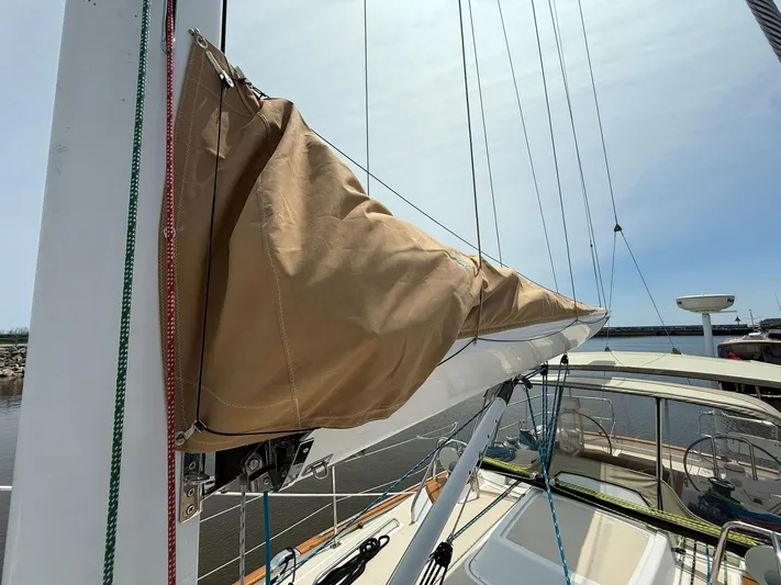 Chapter 9 Yacht Photos Pics Sailboat Tartan 4000, 2012 model, with covered mainsail and rigging, docked under clear sky.