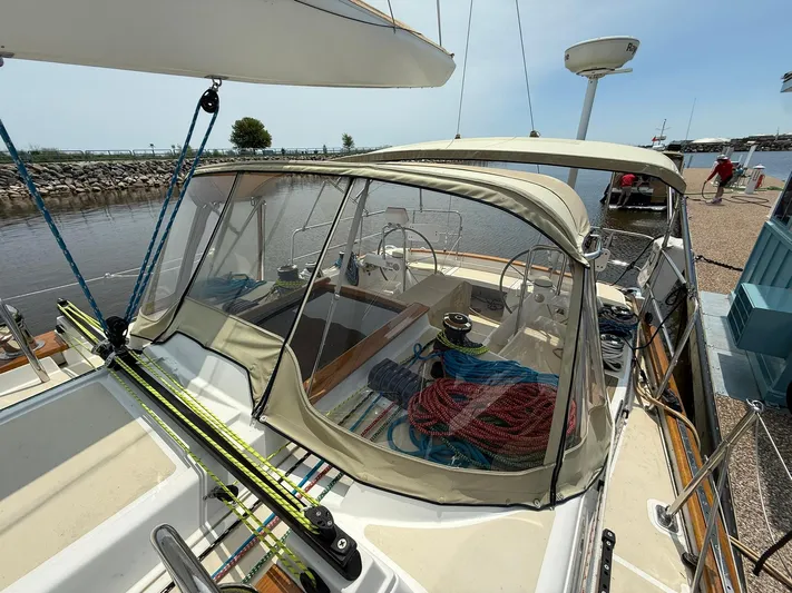 Chapter 9 Yacht Photos Pics Sailboat Tartan 4000, 2012 model, docked with covered cockpit and visible rigging.