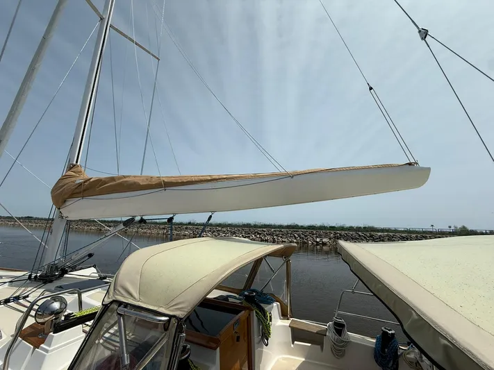 Chapter 9 Yacht Photos Pics Sailboat Tartan 4000, 2012 model, docked with sails furled under a clear sky.