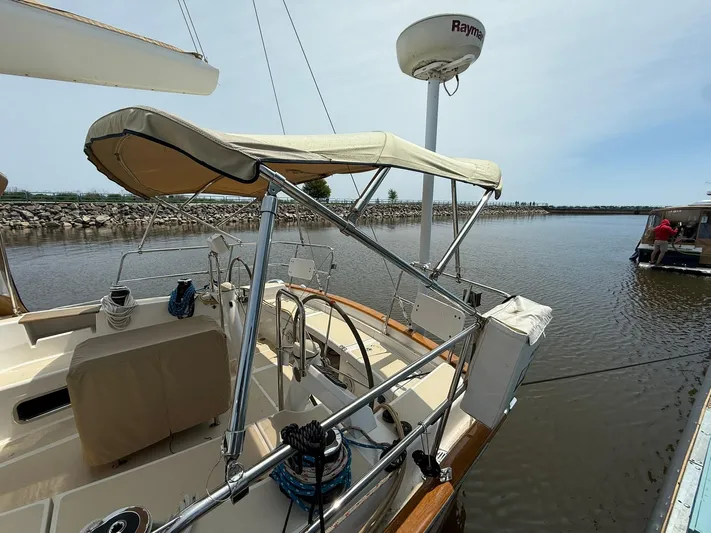Chapter 9 Yacht Photos Pics Sailboat Tartan 4000, 2012 model, docked in calm waters with canopy and radar equipment.
