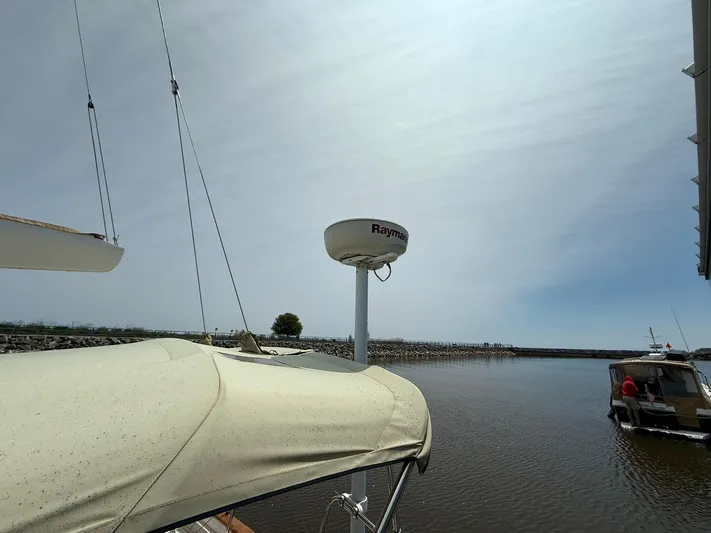 Chapter 9 Yacht Photos Pics Sailboat Tartan 4000 (2012) with radar, docked in calm waters under a clear sky.