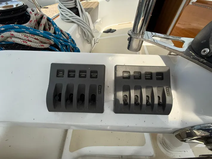 Chapter 9 Yacht Photos Pics Control panel on a 2012 Tartan 4000 sailboat with switches and ropes.