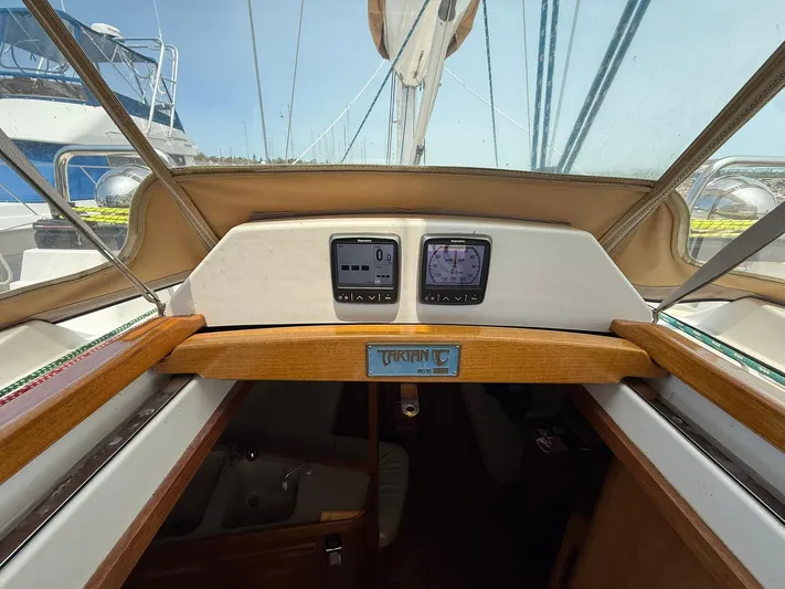 Chapter 9 Yacht Photos Pics Cockpit view of a 2012 Tartan 4000 sailboat, featuring navigation instruments and wooden trim.