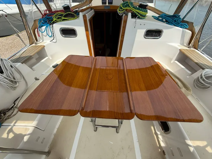 Chapter 9 Yacht Photos Pics Cockpit of 2012 Tartan 4000 sailboat with wooden table and colorful ropes.