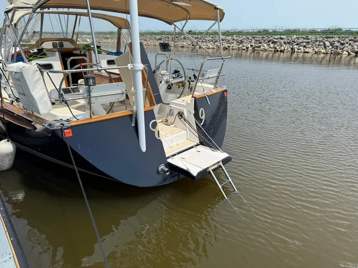 Chapter 9 Yacht Photos Pics Tartan 4000 sailboat, 2012 model, docked in calm waters with a visible swim platform.