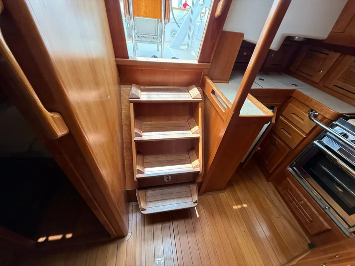 Chapter 9 Yacht Photos Pics Interior of 2012 Tartan 4000 sailboat with wooden stairs and cabinetry.
