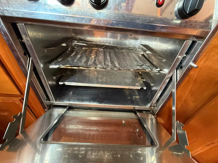 Chapter 9 Yacht Photos Pics Open Tartan 4000 oven, stainless steel interior, showing racks and control knobs, 2012 model.