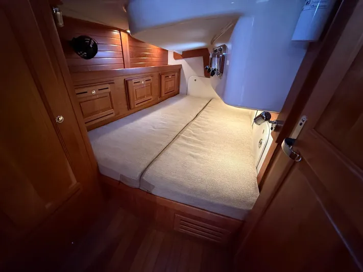 Chapter 9 Yacht Photos Pics Cozy cabin interior of 2012 Tartan 4000 yacht with wooden finish and comfortable bedding.