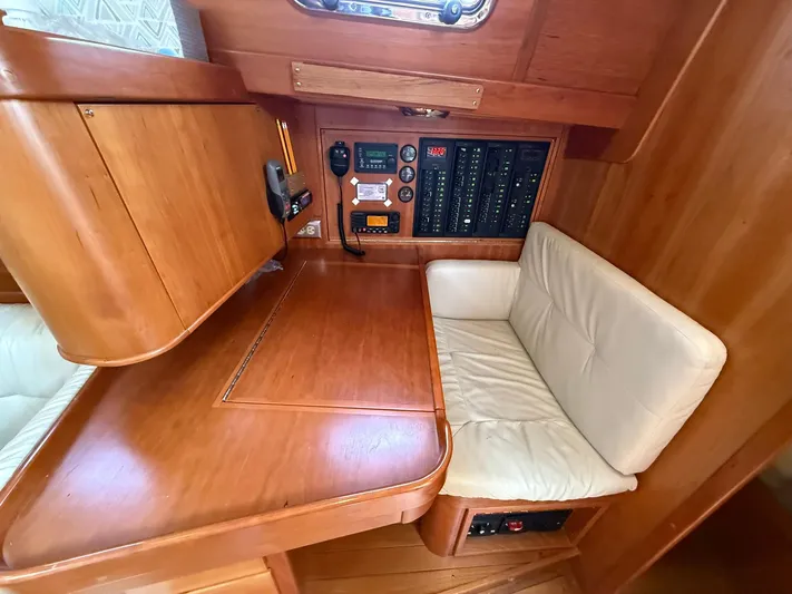 Chapter 9 Yacht Photos Pics Cozy Tartan 4000 yacht interior with navigation panel and cushioned seating, 2012 model.