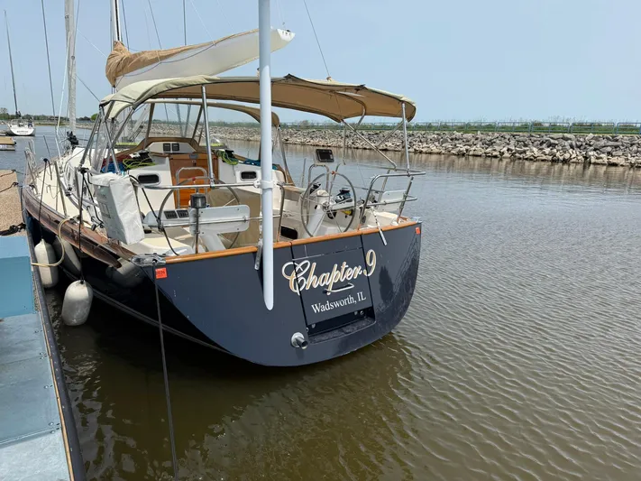 Chapter 9 Yacht Photos Pics Sailboat "Chapter 9" docked, Tartan 4000 model, 2012, in a calm marina setting.