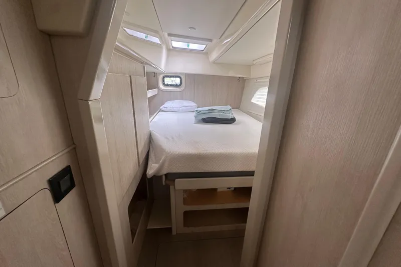 Ohana Yacht Photos Pics Cozy cabin interior of 2016 Leopard 44 yacht with bed and window.
