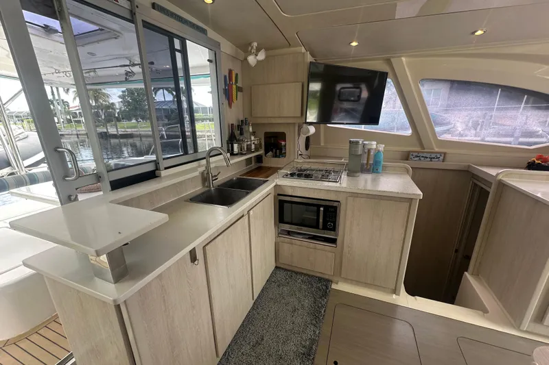 Ohana Yacht Photos Pics Modern kitchen interior on a 2016 Leopard 44 yacht, featuring appliances and large windows.