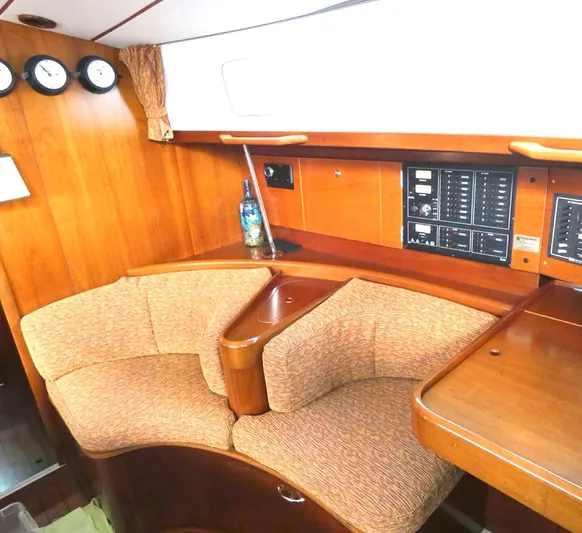 Princessa Yacht Photos Pics Interior of 2000 Beneteau 44 Center Cockpit with wood paneling and seating area.