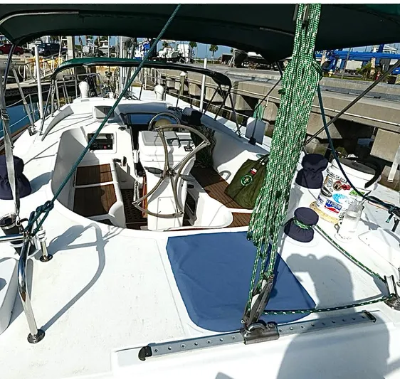 Princessa Yacht Photos Pics 2000 Beneteau 44 Center Cockpit sailboat with green canopy and docked at marina.