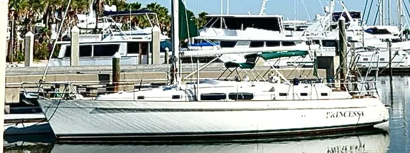 Princessa Yacht Photos Pics 2000 Beneteau 44 Center Cockpit sailboat docked in a marina.