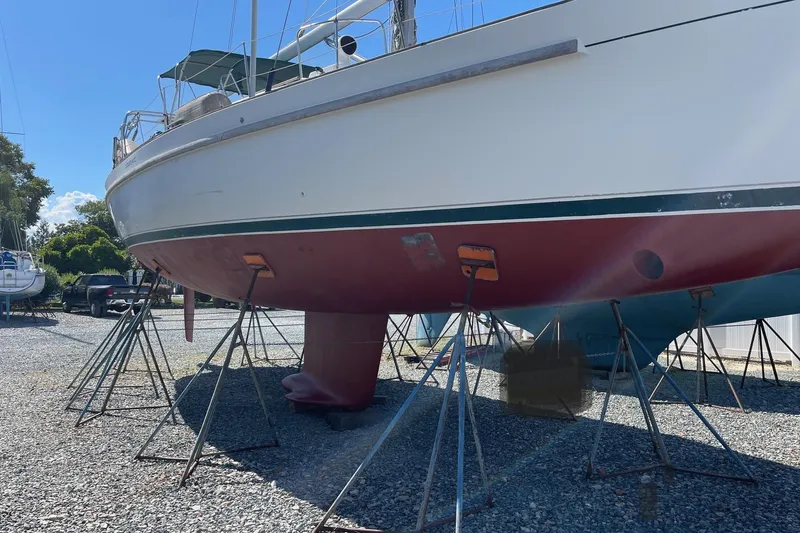 Princessa Yacht Photos Pics 2000 Beneteau 44 Center Cockpit sailboat on stands, hull visible, outdoor storage.