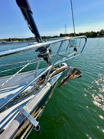 Après Yacht Photos Pics Beneteau 57 sailboat bow with anchor, 2010 model, on calm water under clear sky.