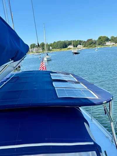 Après Yacht Photos Pics Sailboat Beneteau 57 (2010) with solar panels, docked in a serene harbor.