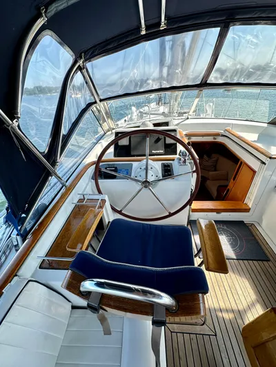 Après Yacht Photos Pics Cockpit of 2010 Beneteau 57 sailboat with wooden accents and steering wheel.