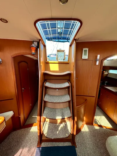 Après Yacht Photos Pics Interior of 2010 Beneteau 57 yacht with wooden stairs and cozy cabin design.