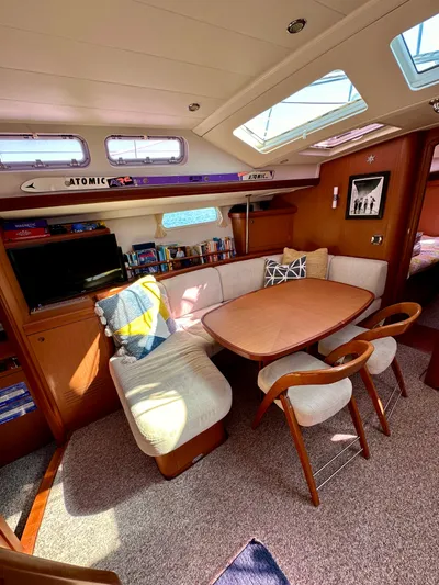 Après Yacht Photos Pics Interior of 2010 Beneteau 57 yacht with cozy dining area and natural light.