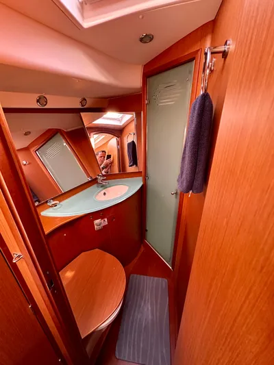 Après Yacht Photos Pics 2010 Beneteau 57 yacht bathroom with wooden interior and modern fixtures.