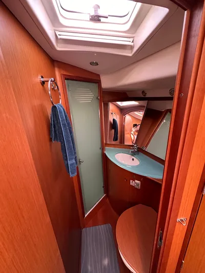 Après Yacht Photos Pics Beneteau 57 yacht bathroom, 2010 model, featuring wood finish and modern fixtures.