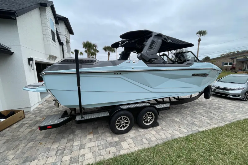 Motivated Yacht Photos Pics 2025 Nautique Super Air Nautique G23 Paragon boat on trailer in driveway.