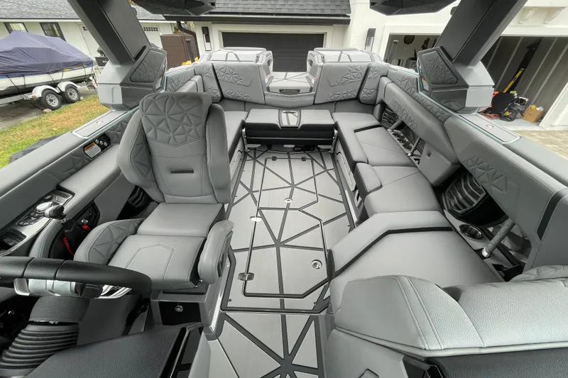 Motivated Yacht Photos Pics 2025 Nautique Super Air Nautique G23 Paragon interior with luxurious gray seating and modern design.