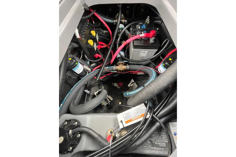 Motivated Yacht Photos Pics Engine compartment of 2025 Nautique Super Air Nautique G23 Paragon with visible wiring and components.