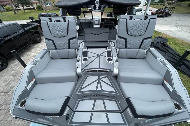 Motivated Yacht Photos Pics 2025 Nautique Super Air Nautique G23 Paragon interior with luxurious gray seating and modern design.