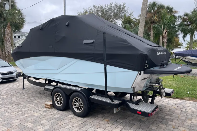 Motivated Yacht Photos Pics 2025 Nautique Super Air Nautique G23 Paragon boat covered on trailer.