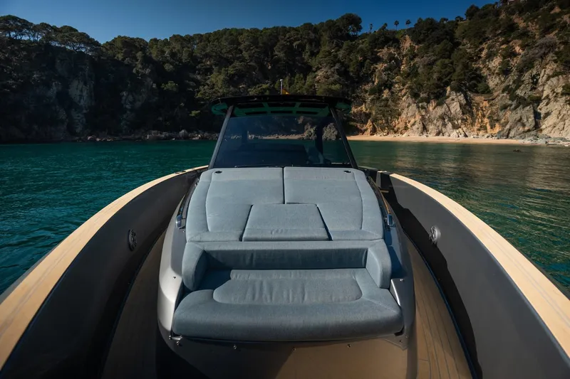  Yacht Photos Pics Luxurious 2026 Pardo Yachts 43 on serene waters near a rocky coastline.