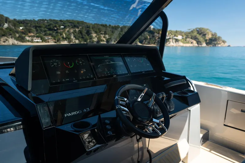  Yacht Photos Pics Helm of 2026 Pardo Yachts 43 with digital displays, steering wheel, and ocean view.