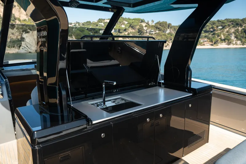  Yacht Photos Pics Luxury outdoor kitchen on 2026 Pardo Yachts 43, featuring sleek black cabinetry and modern sink.