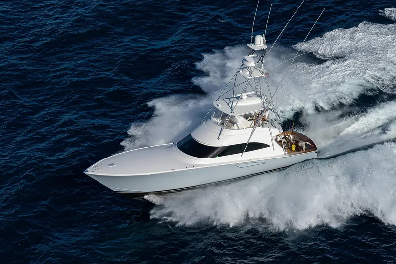  Yacht Photos Pics 2015 Viking 62 Convertible yacht cruising swiftly on open ocean waters.